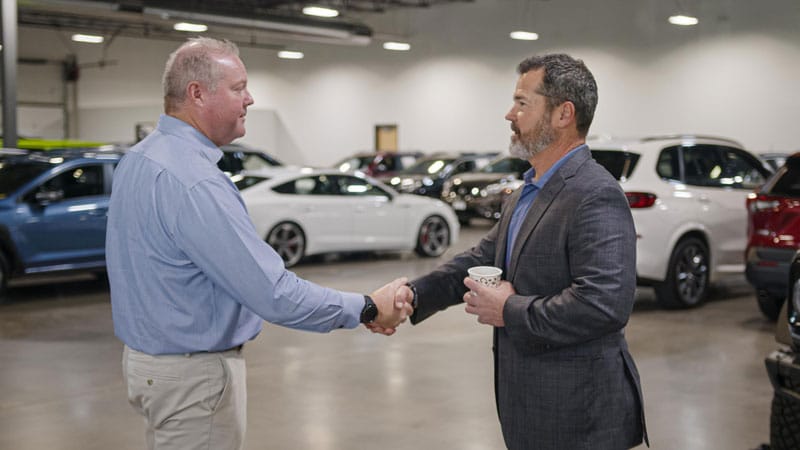 Client shaking hands with a Denver auto broker