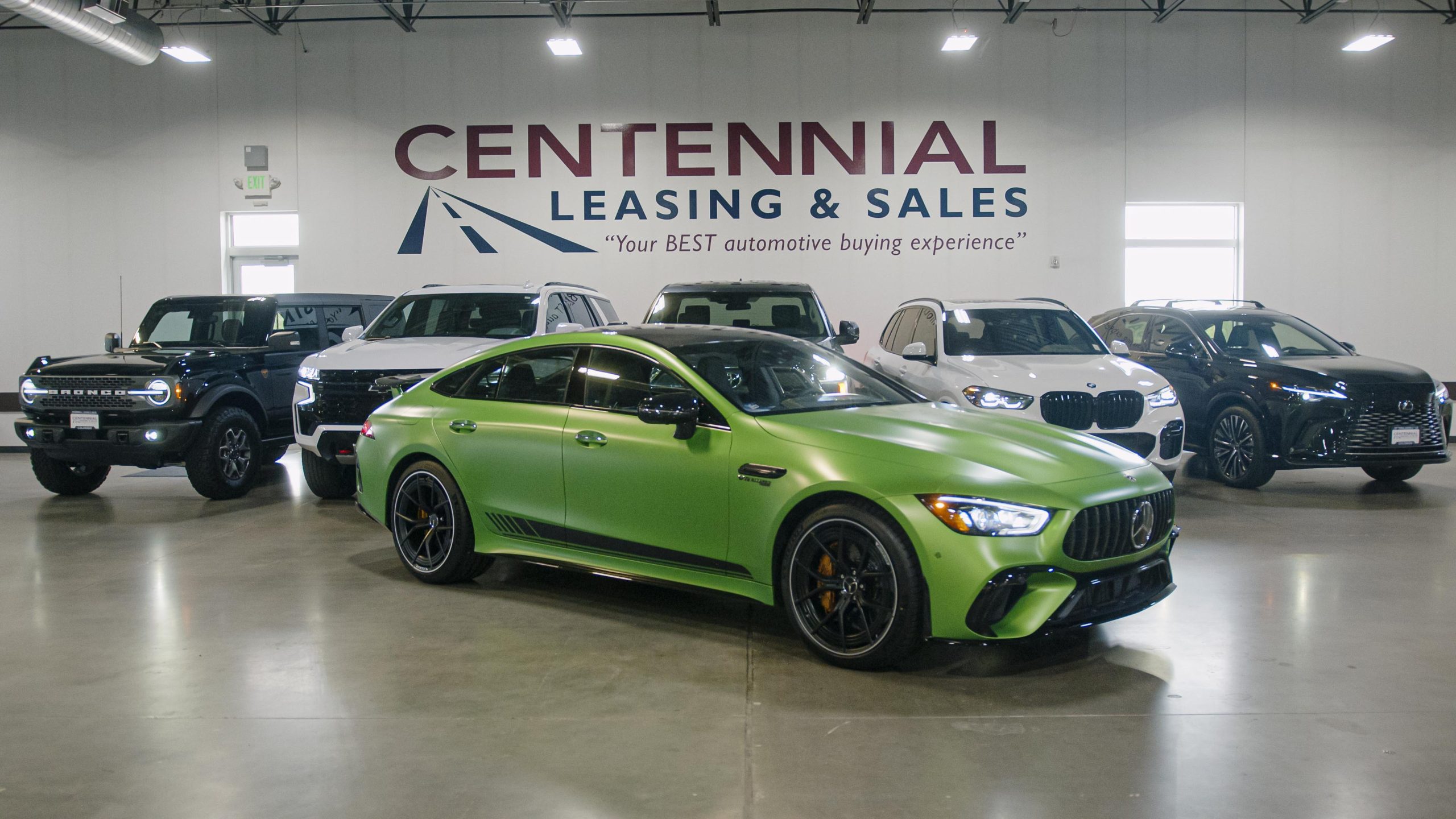 luxury vehicles on display in car showroom