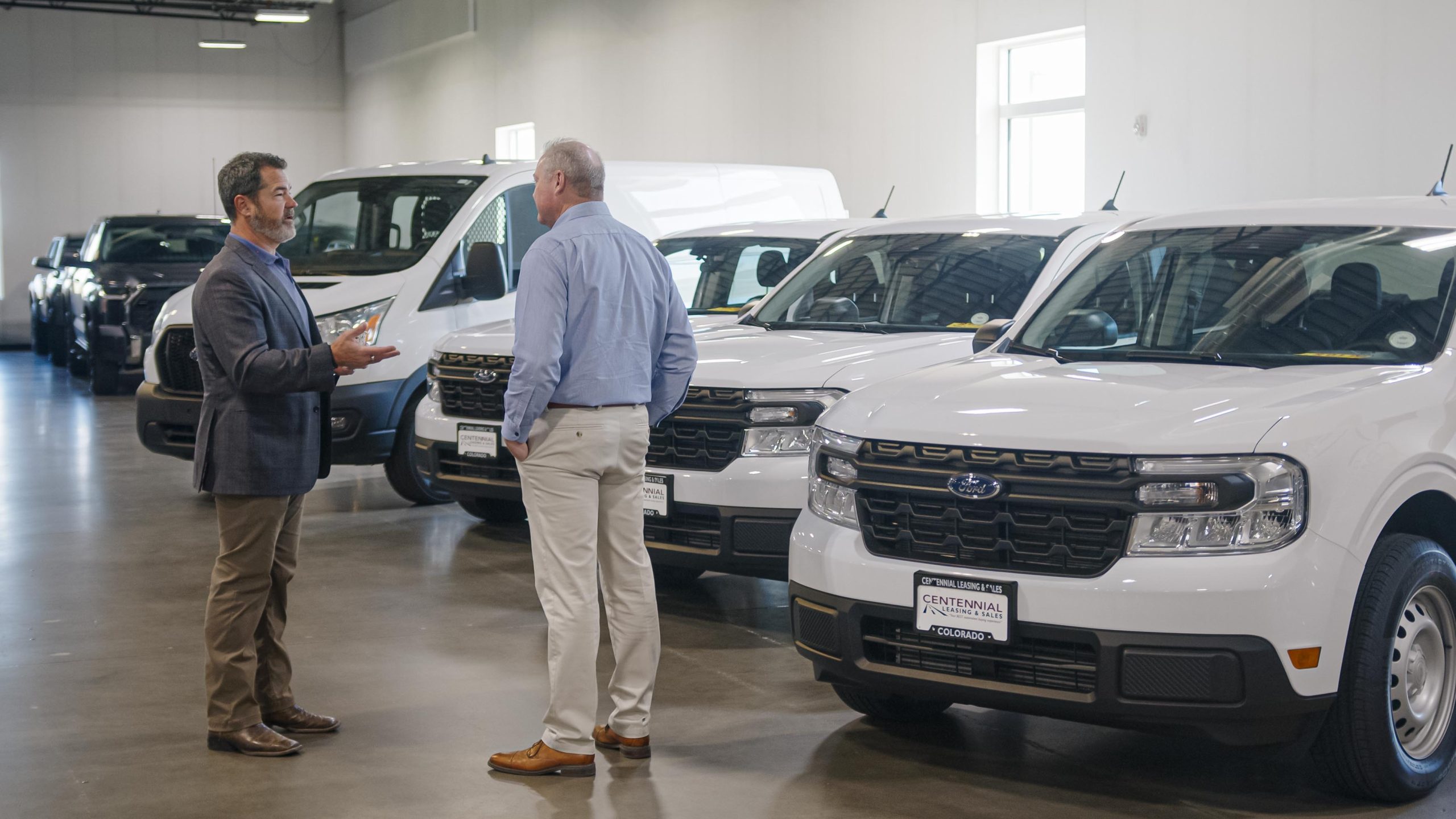 Small business owner speaking with auto broker to lease a commercial fleet